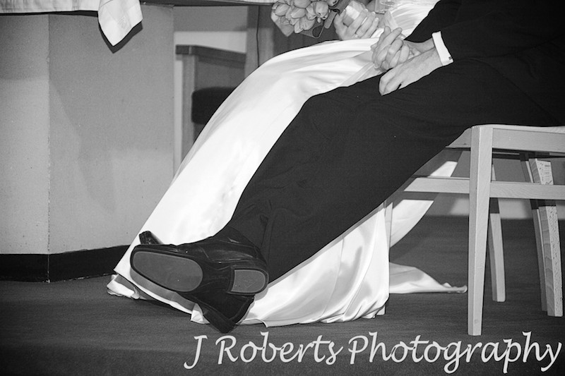 Groom lounging back in church - wedding photography sydney